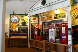 Display of oil company marketing with panels, gas station pumps, and other memorabilia.