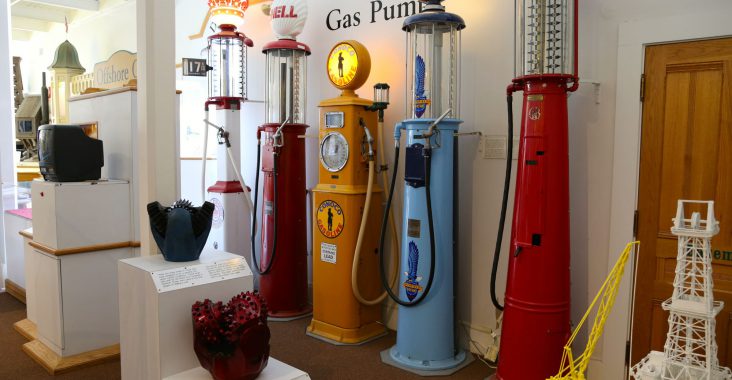 Display of vintage gas pumps and oil drills at the California Oil Museum