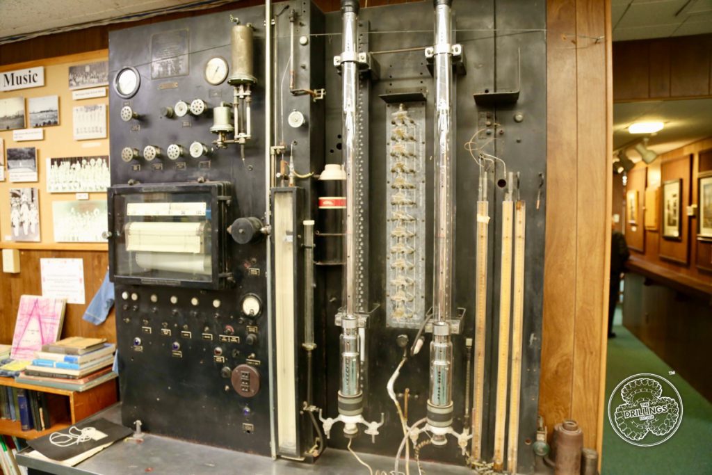 This Hyd-robot (hydraulically operated automatic low-temperature fractional distillation apparatus) was brought used in 1942 from the Watson refinery. (We are searching to find out how old it really is.)  The computer is purely mechanical. Both oil and gas were run, and it is said it took a whole day to get four components. Liquid nitrogen was kept in the thermos.